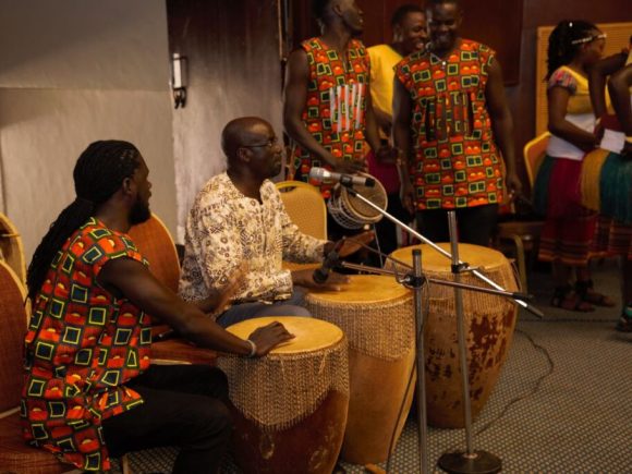 Dr. Milton Wabyona from the Makerere University Department of Music, Dance and Drama (center) entertaining the guests in traditional music folklore.