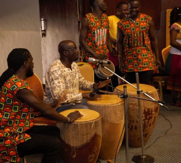 Dr. Milton Wabyona from the Makerere University Department of Music, Dance and Drama (center) entertaining the guests in traditional music folklore.