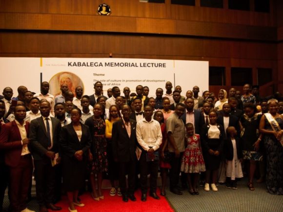 A cross-section of students and some of the participants who took part in the lecture posing for a photo with Prof. PLO. Lumumba